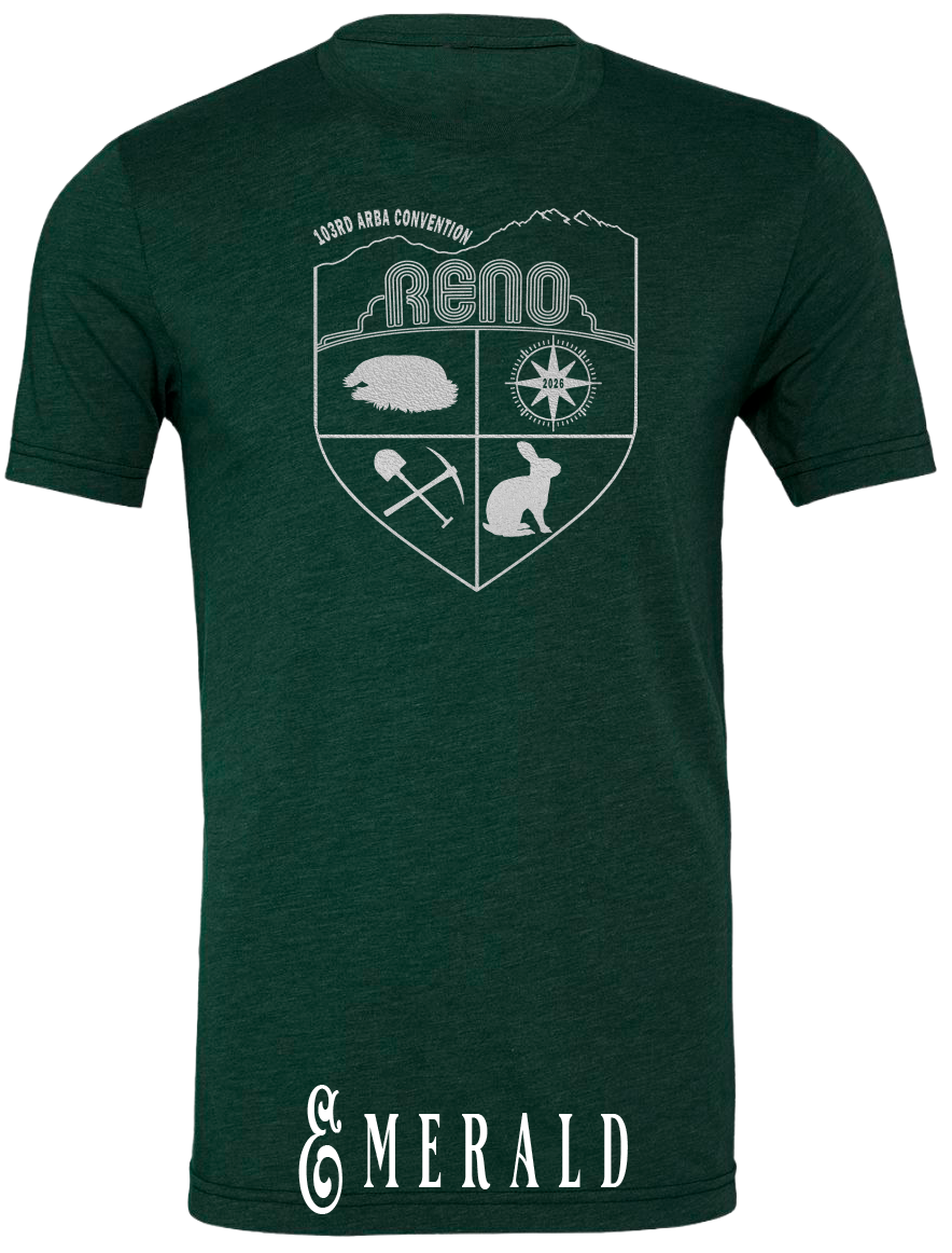 Emerald triblend t-shirt with the Biggest Little Reunion crest in metallic silver - a rabbit, a cavy, a pick and shovel, and a compass under the Reno arch. 103rd ARBA Convention.