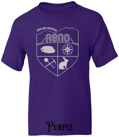 Purple youth t-shirt with the Biggest Little Reunion crest in metallic silver - a rabbit, a cavy, a pick and shovel, and a compass under the Reno arch. 103rd ARBA Convention.